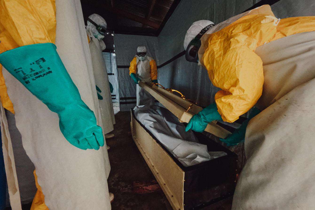 Staff disinfect and seal the coffin of a deceased Ebola patient in DR Congo.