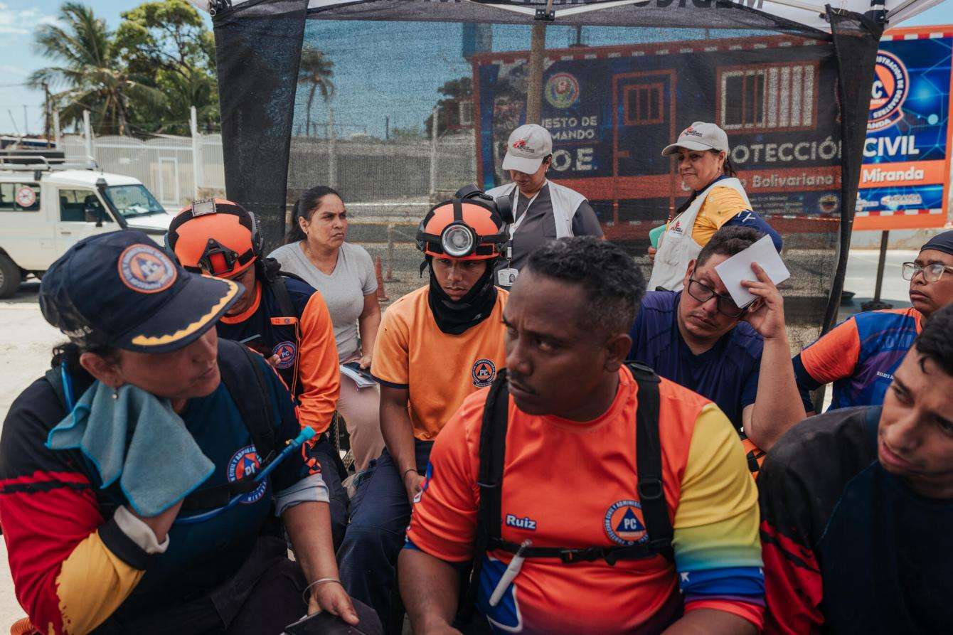 Members of Venezuelan Civil Protection line up to receive medical attention at an MSF mobile clinic in Playa Grande, Venezuela.