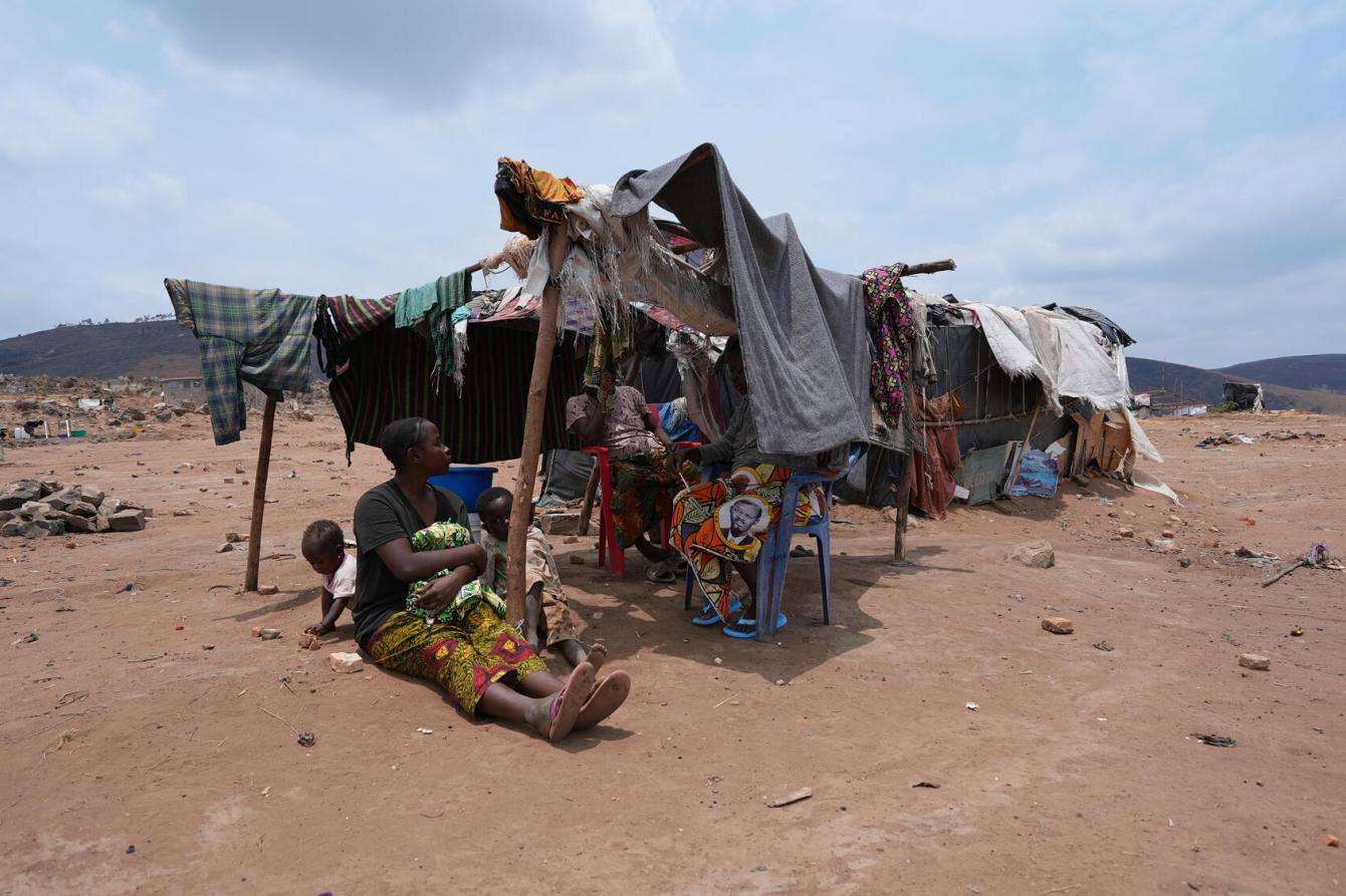 A woman sits under a makeshift tent in Burundi. 