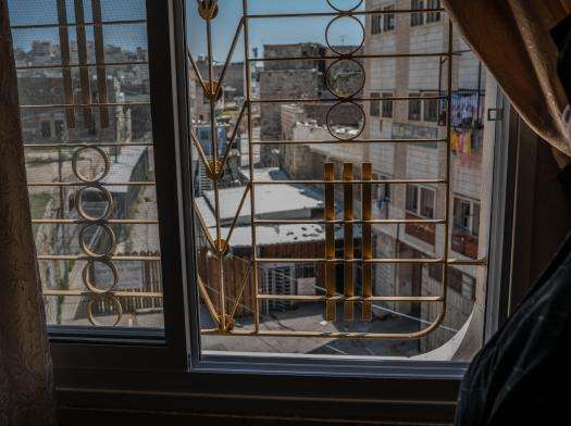 View from a window in the old city of Hebron, overlooking Israeli settlements.