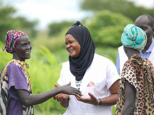 MSF nurse activity manager Awa Abdou smiles while talking to patients in South Sudan