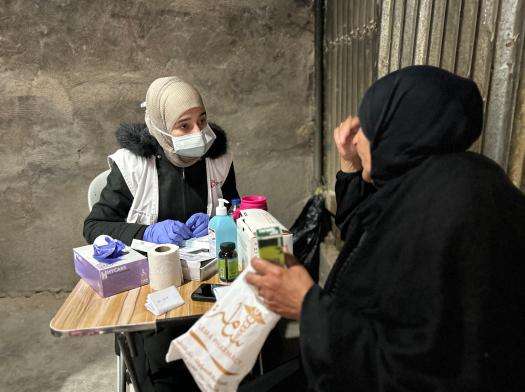 A Palestinian woman speaks to an MSF staff member at a mobile clinic in the occupied West Bank.