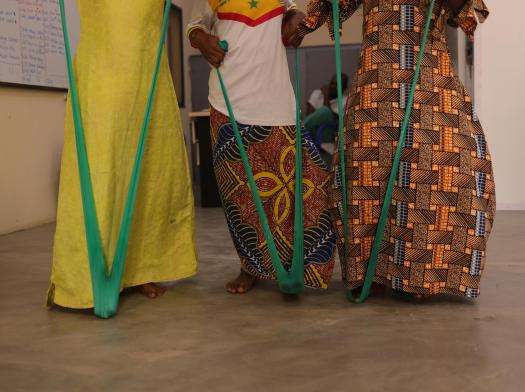 Three women attend a physiotherapy session in Nigeria. 