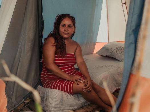 A portrait of Karely Lopez, 30, inside her tent in a temporary encampment set up outside Mare Abajo, a housing complex that partially collapsed during the twin earthquakes in Venezuela.