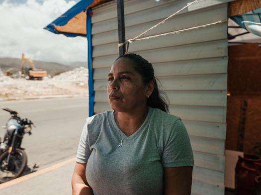 Yusmari Romero, 46, sits outside her makeshift shelter in a public school in Playa Grande, which temporarily houses people displaced after their housing complex collapsed during the twin earthquakes in Venezuela.
