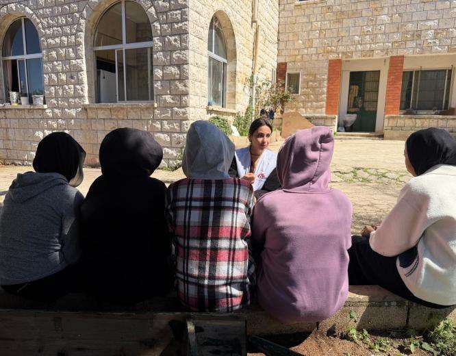 An MSF staff member in Lebanon speals with patients. 