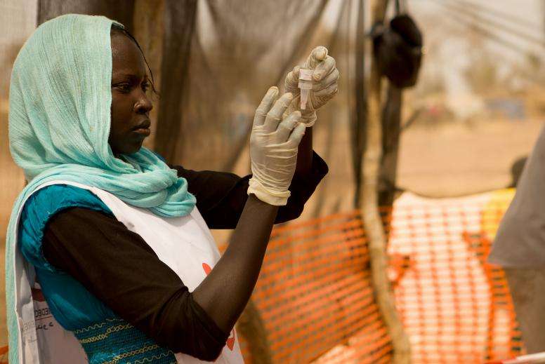 A woman prepares a polio vaccine