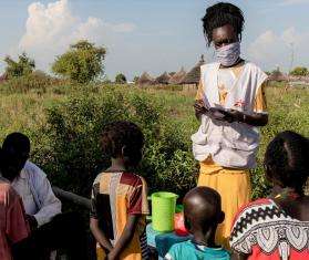 An MSF staff member gives SMC medication to children in a village in Aweil, South Sudan