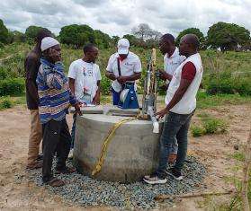 The MSF team checks one of the safeguarded wells equipped with hand pump systems built by MSF to facilitate access to water for communities.