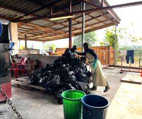 MSF staff stack trash bags for incineration in Sierra Leone. 