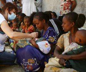 An MSF nurse screens a child for malnutrition at a mobile clinic in Adiftaw in 2021 in Tigray, Ethiopia.