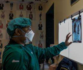 An MSF doctor in India looks at an X-ray of a lung. 