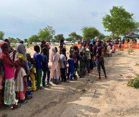 Line of Sudanese refugees outside waiting for MSF vaccines in Central African Republic