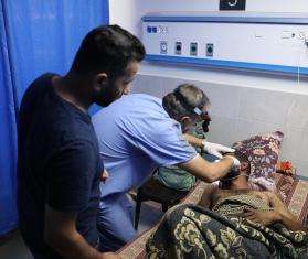 Medical staff treat a patient at Al Shifa Hospital in Gaza