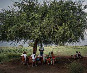 A community group led by MSF sits under a tree in Abyei, South Sudan.