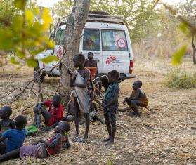 A group of children beside an MSF vehicle during health outreach activities in Boma, South Sudan.