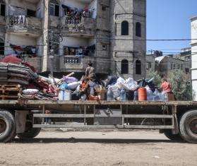 Displaced Palestinians in Gaza flee Rafah with their belongings on a truck.