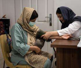 A doctor checks a pregnant woman's blood pressure at the MSF-run Mehr clinic in southwest Tehran, where vulnerable people, including refugees and others, can access free health care.