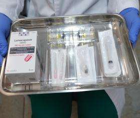 A doctor holds a tray of the HIV medication lenacapavir.