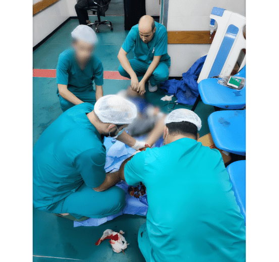 MSF doctors amputate a small child's leg in Gaza.