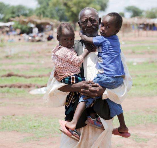 Hamad Mohamod, displaced person from Sudan, with two small children.
