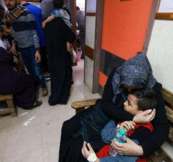 A mother hugs her child at Al-Aqsa Hospital in Gaza.