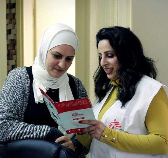 MSF intercultural mediator Noura Arafat, right, with a patient in Palestine.