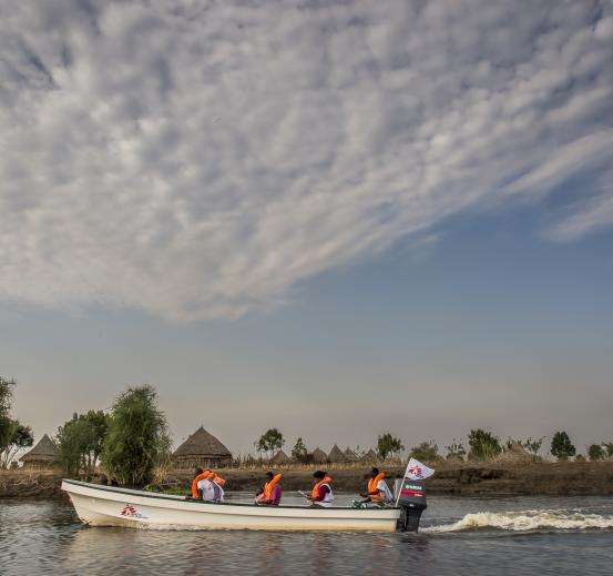 An MSF boat speeds on the Pibor River