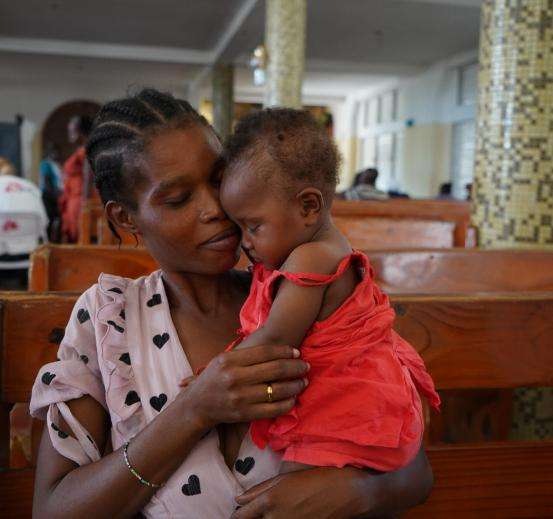 A mother holds her child in Haiti. 