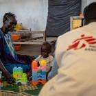 A mother sits next to her child at a clinic in Ethiopia. 