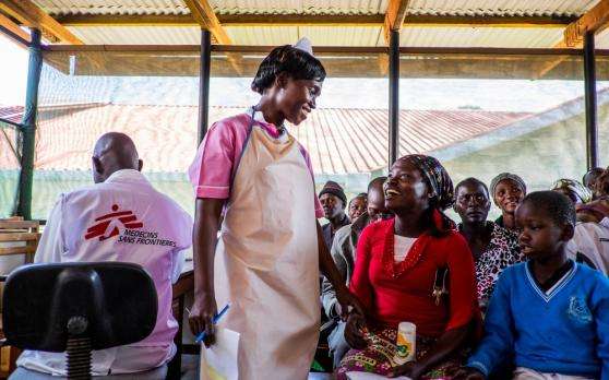 In the HIV department of Arua Regional hospital-Uganda, a patient and MSF staff member smile at one another warmly